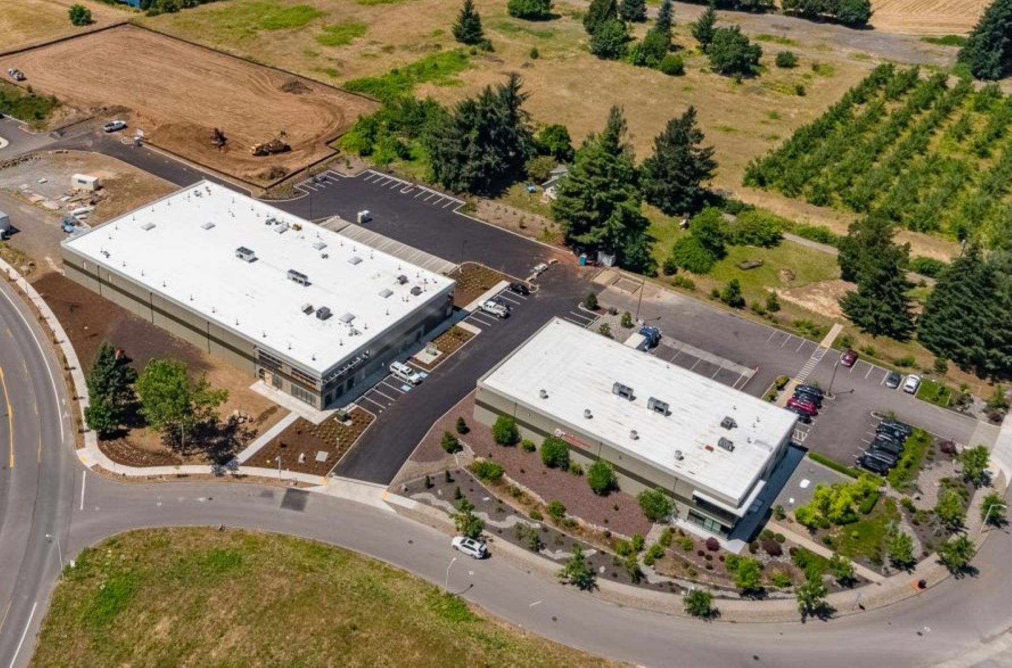 Dragonberry Produce fly over picture of two industrial buildings surrounded by greenery