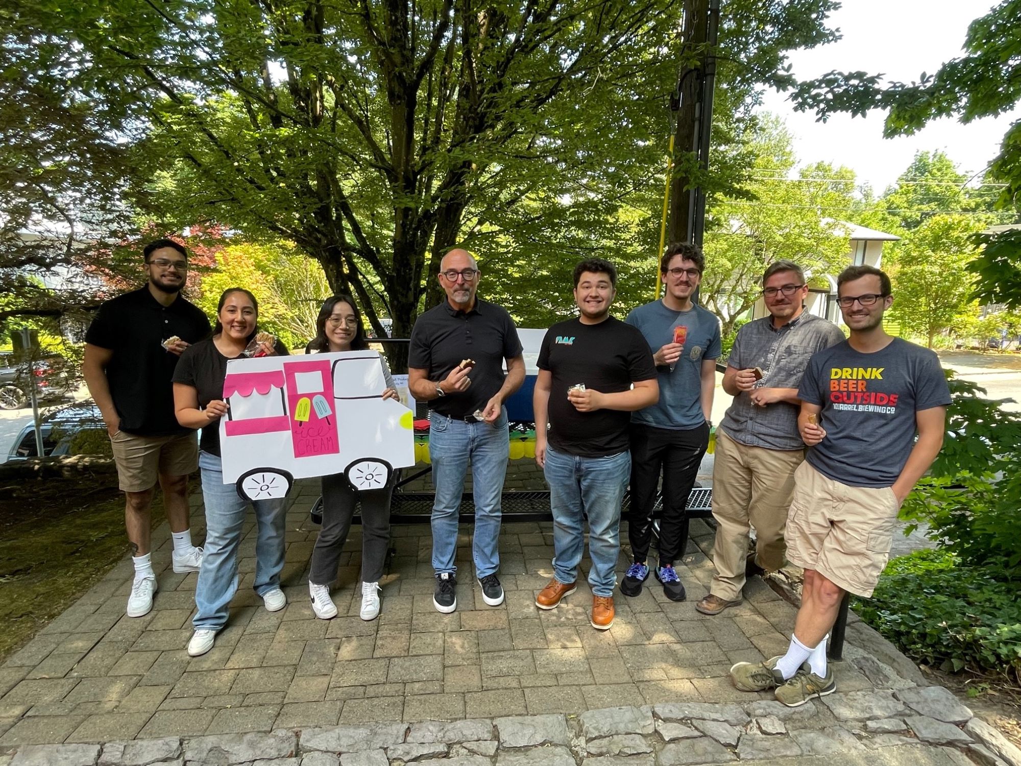 VLMK First Friday – frozen treats VLMK staff outside by a picnic table eating frozen treats
